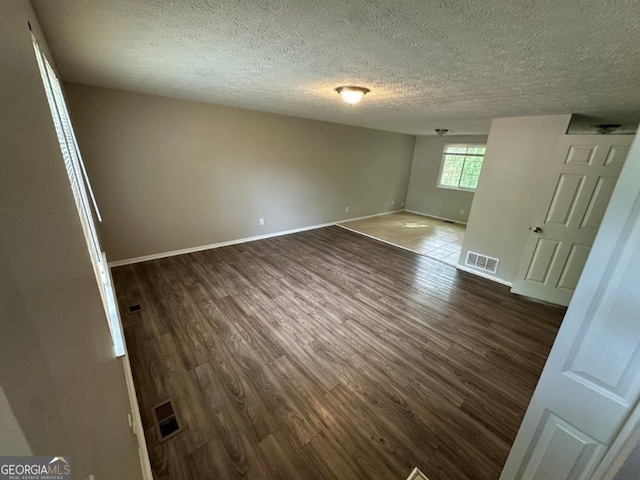 2036 Countydown Ln, Stone Mountain, GA 30088 - empty room featuring dark wood finished floors, a textured ceiling, and baseboards