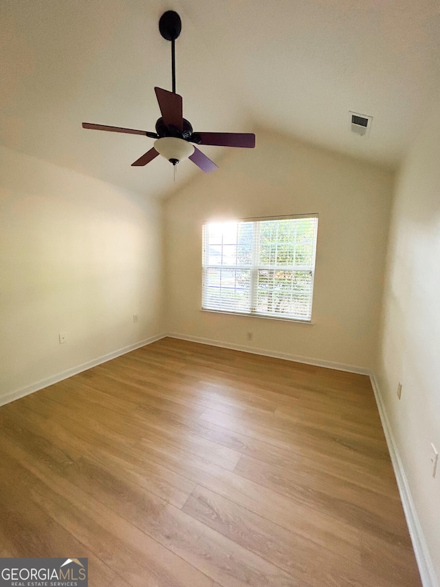 3077 Oakside Cir, Milton, GA 30004 - empty room featuring light wood-type flooring, ceiling fan, and vaulted ceiling
