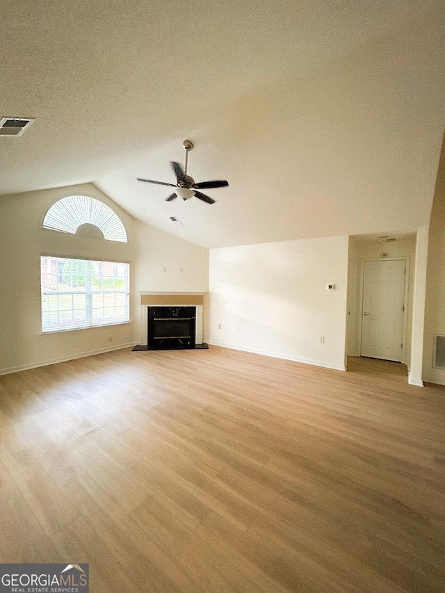 3077 Oakside Cir, Milton, GA 30004 - unfurnished living room featuring lofted ceiling, a ceiling fan, light wood-style floors, and a high end fireplace