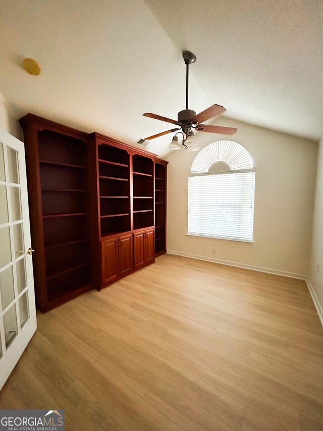 3077 Oakside Cir, Milton, GA 30004 - unfurnished living room with light wood finished floors, a ceiling fan, and vaulted ceiling