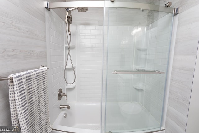 bathroom featuring shower / bath combination with glass door