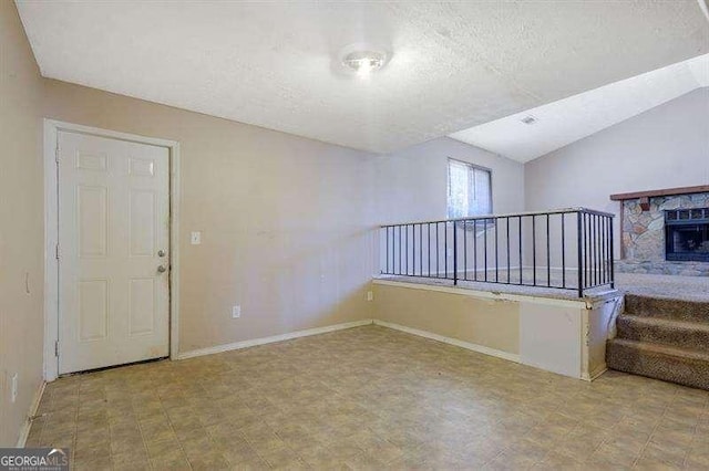 1045 Forest Path, Stone Mountain, GA 30088 - unfurnished living room with a textured ceiling and vaulted ceiling