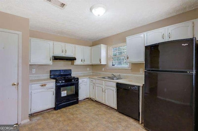 kitchen featuring visible vents, light countertops, ventilation hood, white cabinetry, and black appliances
