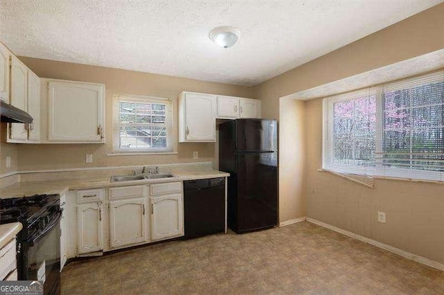 kitchen featuring a sink, white cabinets, black appliances, and light countertops
