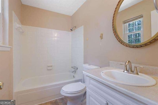 full bathroom with vanity, a textured ceiling, tub / shower combination, and toilet