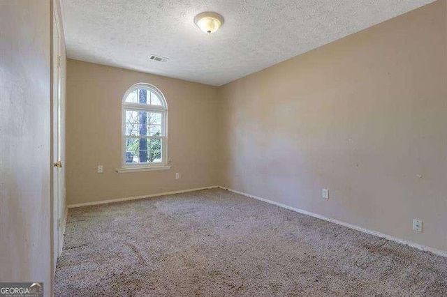 1045 Forest Path, Stone Mountain, GA 30088 - carpeted spare room with a textured ceiling and baseboards