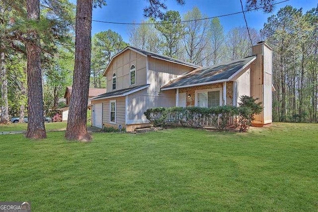 view of front of property with a chimney and a front lawn