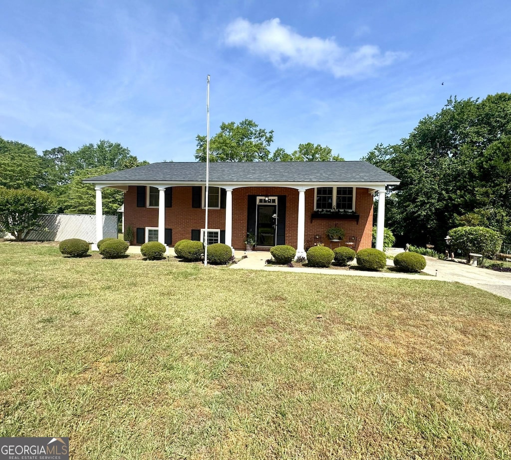 412 Woods Ave, Dublin, GA 31021 - view of front facade with brick siding, fence, and a front yard