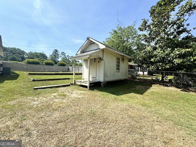 view of outbuilding featuring a fenced backyard, central AC unit, and an outdoor structure
