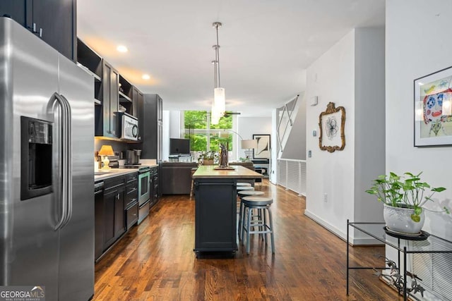 1346 Peter Haughton Way NW, Atlanta, GA 30318 - kitchen featuring stainless steel appliances, a kitchen island, dark wood finished floors, and a breakfast bar area