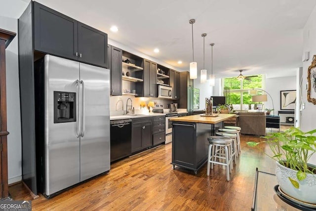 1346 Peter Haughton Way NW, Atlanta, GA 30318 - kitchen featuring appliances with stainless steel finishes, open shelves, a center island, wood finished floors, and wooden counters
