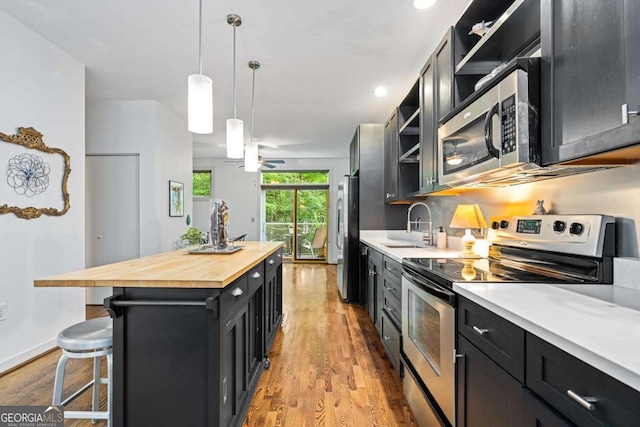 1346 Peter Haughton Way NW, Atlanta, GA 30318 - kitchen with stainless steel appliances, dark cabinets, wooden counters, open shelves, and light wood finished floors