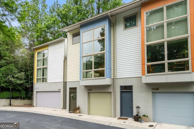 1346 Peter Haughton Way NW, Atlanta, GA 30318 - view of front facade with stucco siding and an attached garage