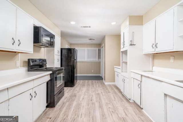 1774 Campbellton Rd, Atlanta, GA 30311 - kitchen with black appliances, light wood-style floors, and white cabinets