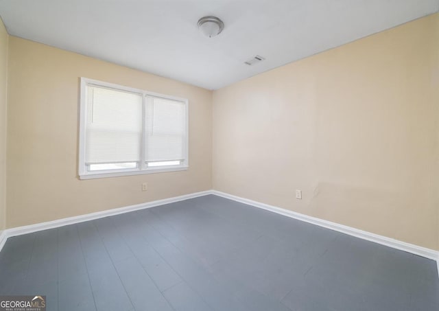 1774 Campbellton Rd, Atlanta, GA 30311 - spare room featuring baseboards, dark wood-type flooring, and visible vents