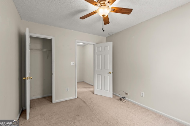 unfurnished bedroom with carpet floors, baseboards, a closet, and a textured ceiling