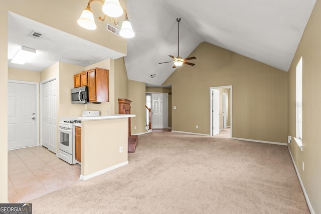 kitchen with ceiling fan, stainless steel microwave, white range with gas stovetop, and visible vents