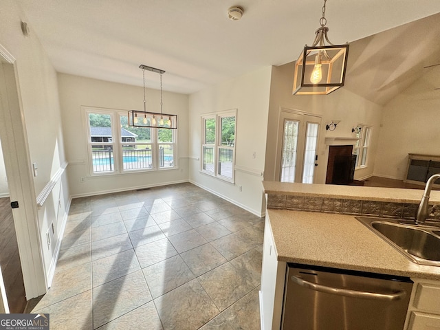 kitchen with an inviting chandelier, open floor plan, a sink, dishwasher, and decorative light fixtures
