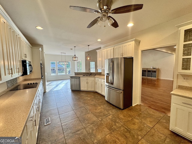 kitchen with ceiling fan, a sink, a peninsula, recessed lighting, and black appliances