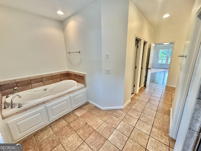 full bathroom with recessed lighting, baseboards, and a garden tub