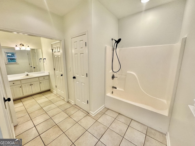 bathroom with vanity, tile patterned flooring, baseboards, and  shower combination