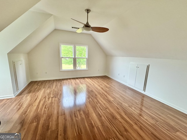 bonus room with a ceiling fan, visible vents, wood finished floors, baseboards, and lofted ceiling