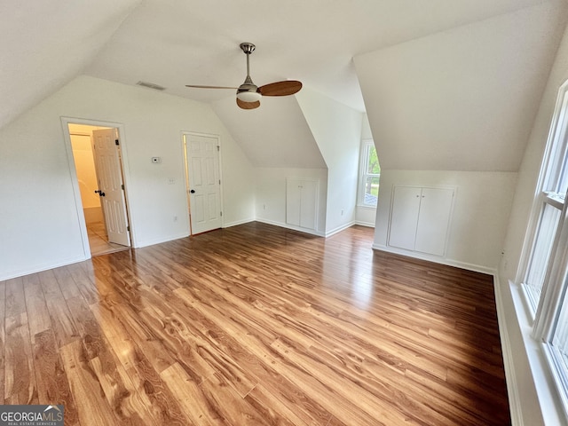 additional living space featuring ceiling fan, visible vents, vaulted ceiling, baseboards, and light wood finished floors