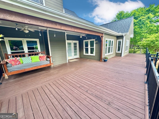deck featuring a ceiling fan and french doors