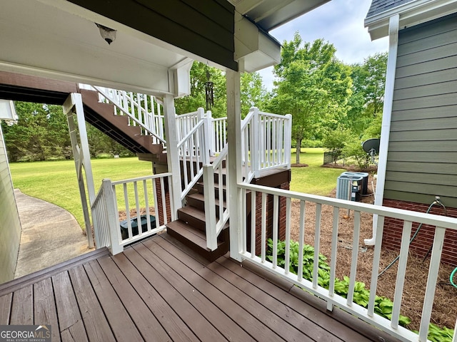 wooden deck featuring a yard and stairway