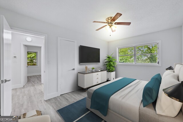 empty room with dark wood-type flooring, baseboards, ceiling fan, and a textured ceiling