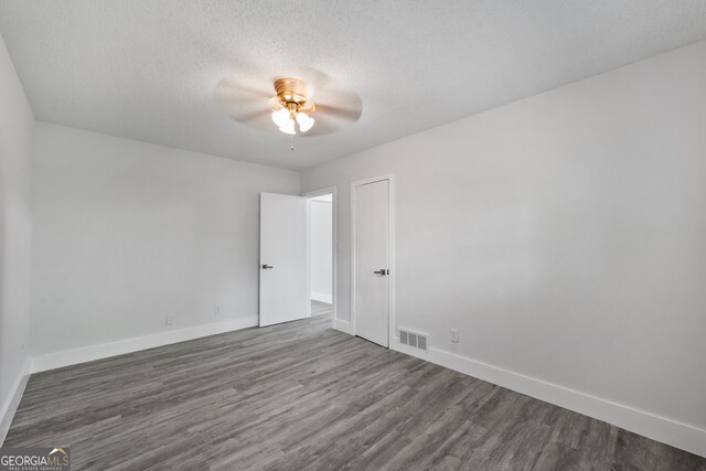 bedroom featuring a textured ceiling, ceiling fan, and wood finished floors