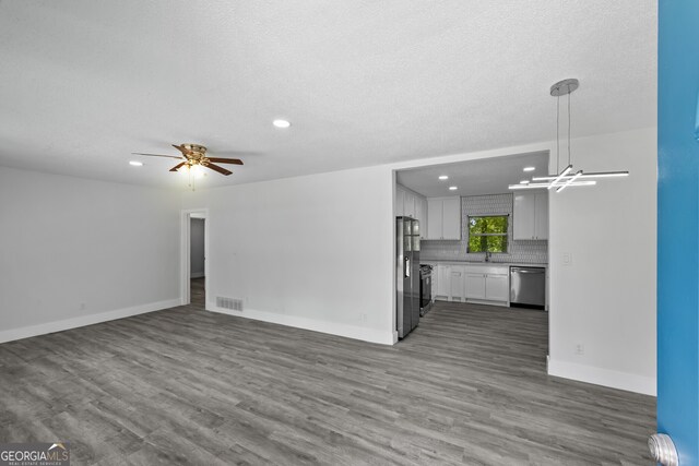 unfurnished living room featuring visible vents, wood finished floors, baseboards, ceiling fan, and recessed lighting