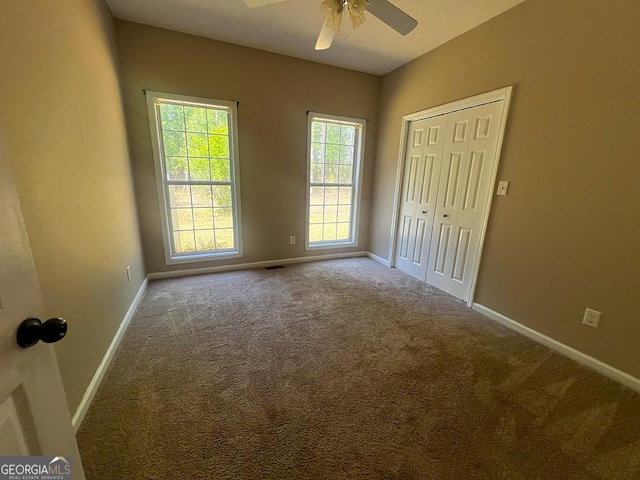 unfurnished bedroom with a closet, baseboards, and carpet flooring