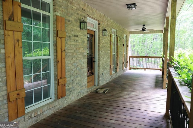 wooden deck with a porch and ceiling fan