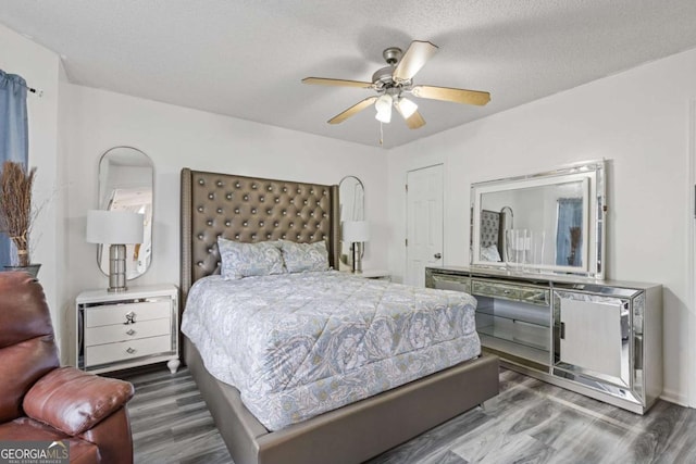 bedroom with a ceiling fan and wood finished floors