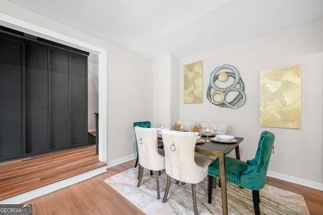 dining room featuring baseboards and wood finished floors