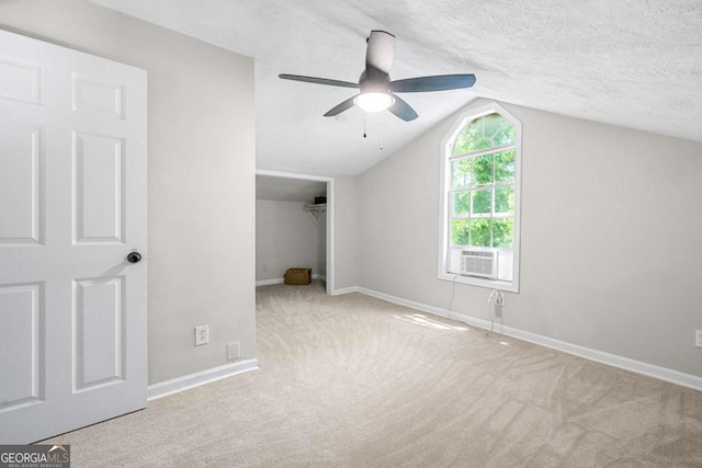 unfurnished bedroom with carpet flooring, baseboards, vaulted ceiling, and a closet