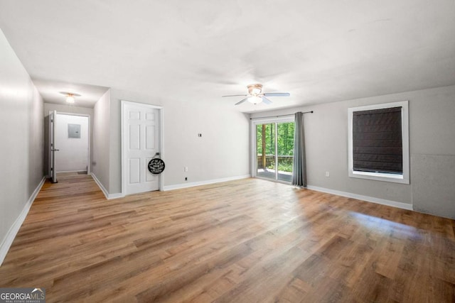 interior space featuring light wood-type flooring, baseboards, and ceiling fan