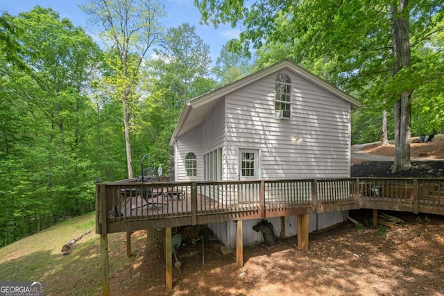 back of house featuring a wooden deck