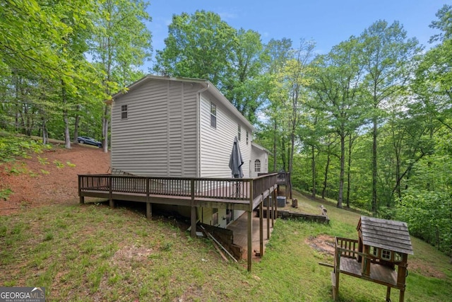 exterior space with a lawn and a wooden deck