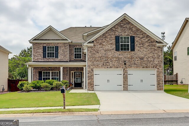 5601 Savannah River Rd, Atlanta, GA 30349 - craftsman-style home with concrete driveway, brick siding, fence, and a front lawn