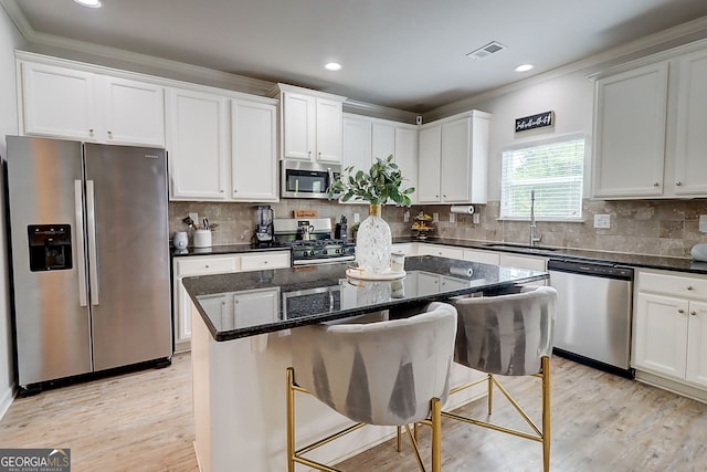 5601 Savannah River Rd, Atlanta, GA 30349 - kitchen with a sink, appliances with stainless steel finishes, ornamental molding, and white cabinetry