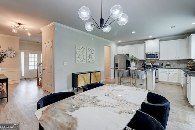 5601 Savannah River Rd, Atlanta, GA 30349 - dining space featuring visible vents, crown molding, light wood finished floors, a chandelier, and recessed lighting