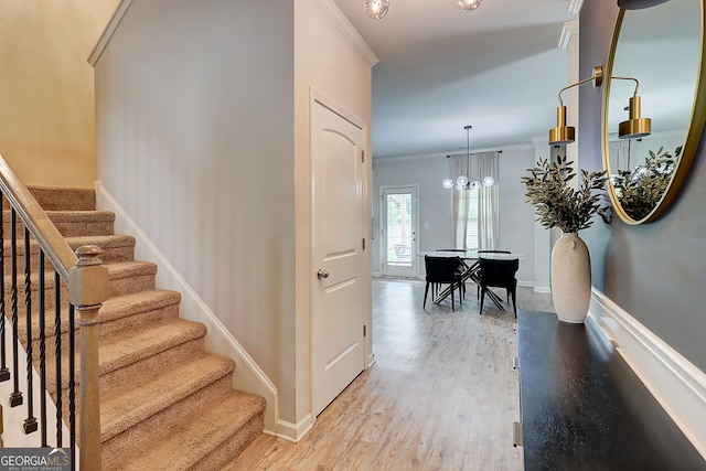5601 Savannah River Rd, Atlanta, GA 30349 - stairs featuring baseboards, ornamental molding, wood finished floors, and a chandelier