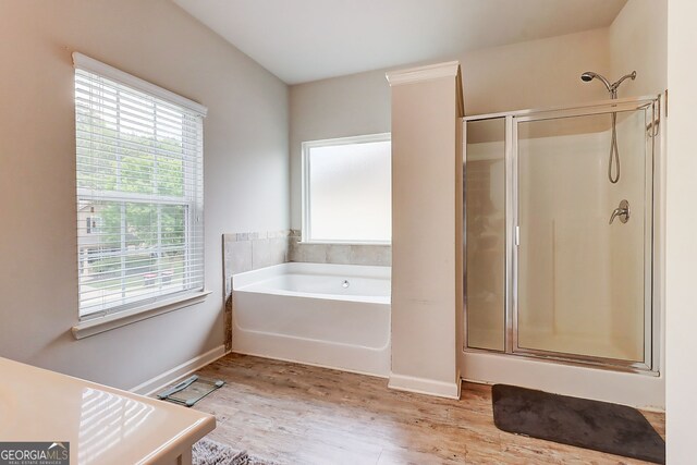 5601 Savannah River Rd, Atlanta, GA 30349 - full bathroom with a bath, baseboards, a stall shower, and wood finished floors