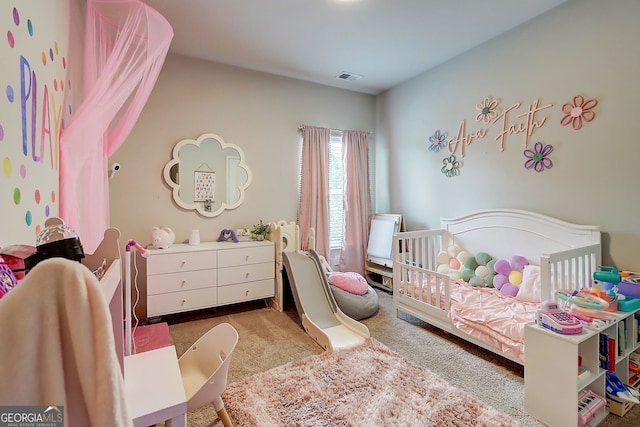 5601 Savannah River Rd, Atlanta, GA 30349 - carpeted bedroom featuring visible vents and a crib