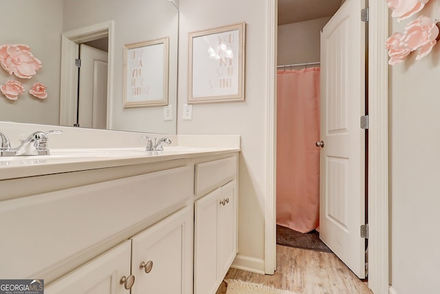 5601 Savannah River Rd, Atlanta, GA 30349 - full bathroom with baseboards, wood finished floors, and vanity