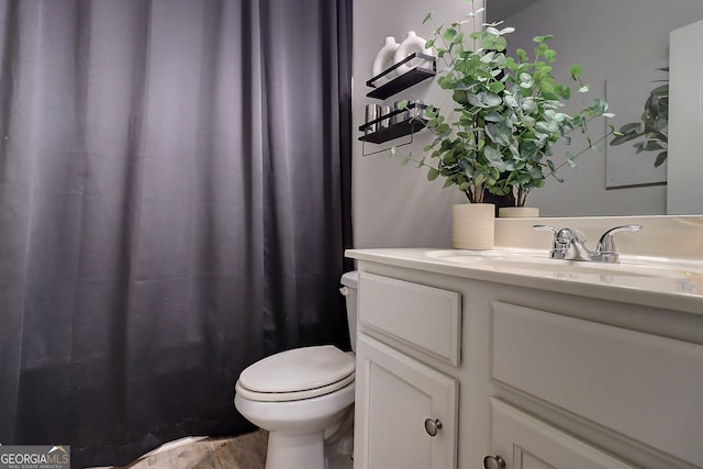 5601 Savannah River Rd, Atlanta, GA 30349 - full bathroom with vanity, a shower with curtain, toilet, and wood finished floors