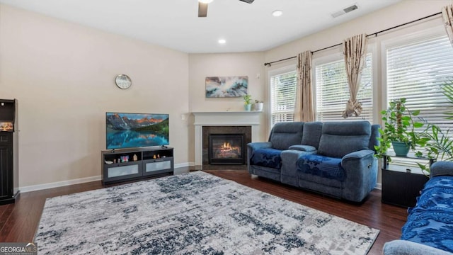 1155 Hampton Oaks Dr, Alpharetta, GA 30004 - living area with visible vents, a glass covered fireplace, baseboards, ceiling fan, and dark wood-style floors