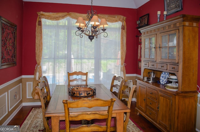 dining space with an inviting chandelier, plenty of natural light, wainscoting, and dark wood-style flooring